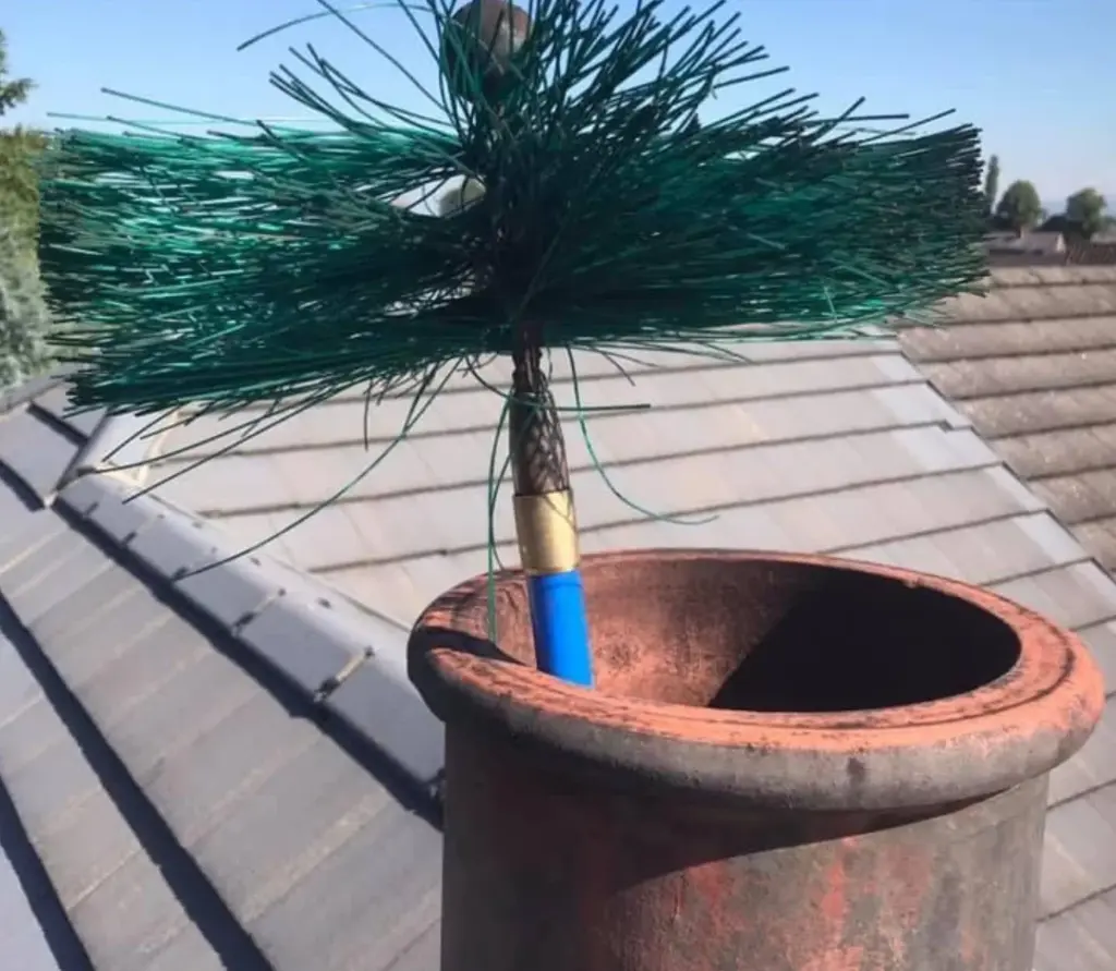 A picture of a chimney sweeps brush cleaning a chimney