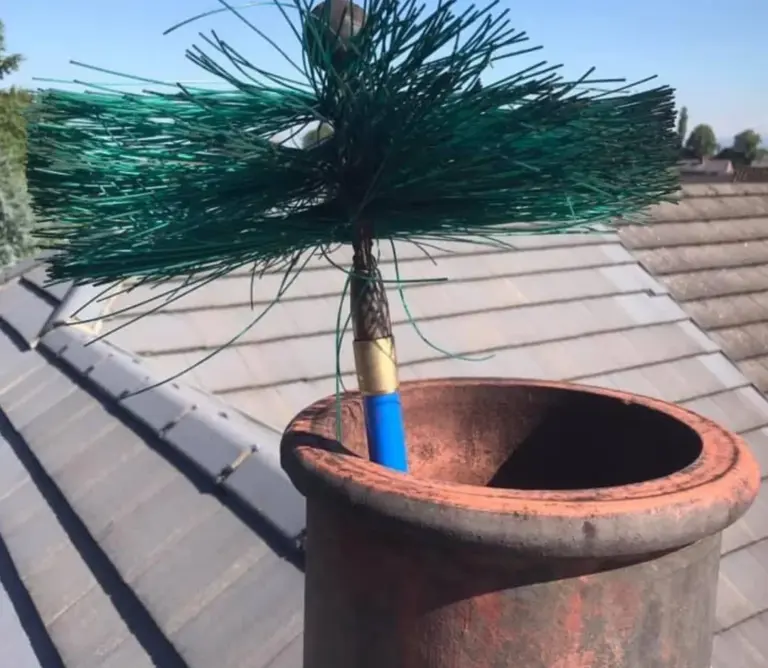 A picture of a chimney sweeps brush cleaning a chimney