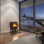 Jotul F105 4.9kW Wood Burning Stove With Long Legs installed on a flat wall